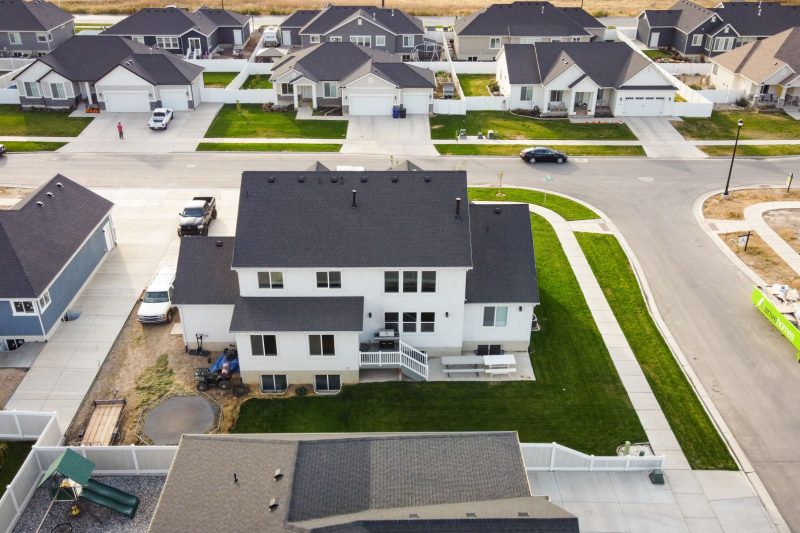 Aerial view of a suburban neighborhood in Spanish Fork, Utah, featuring modern homes and green lawns.
